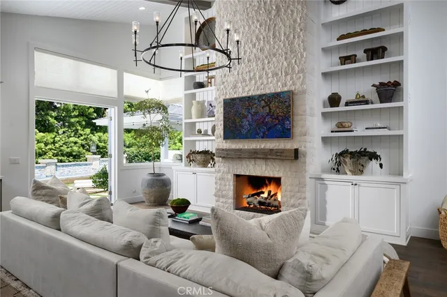 a living room with furniture a fireplace and a large window