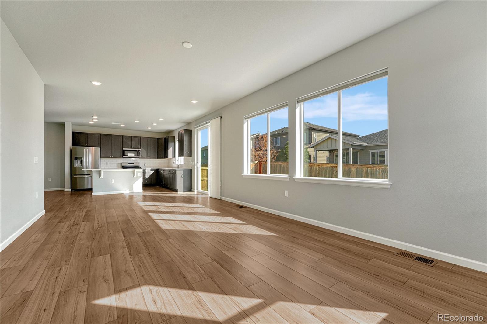 15902 Stringhalt Way Parker, CO 80134 - Photo 23 of 48 a view of kitchen with furniture and wooden floor
