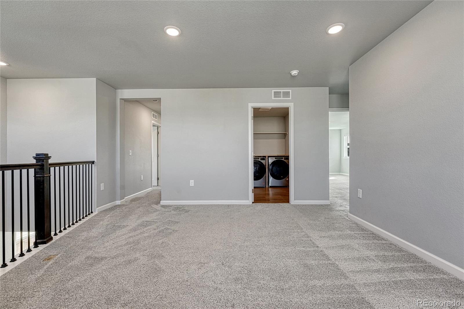15902 Stringhalt Way Parker, CO 80134 - Photo 28 of 48 an empty room with wooden floor and natural light
