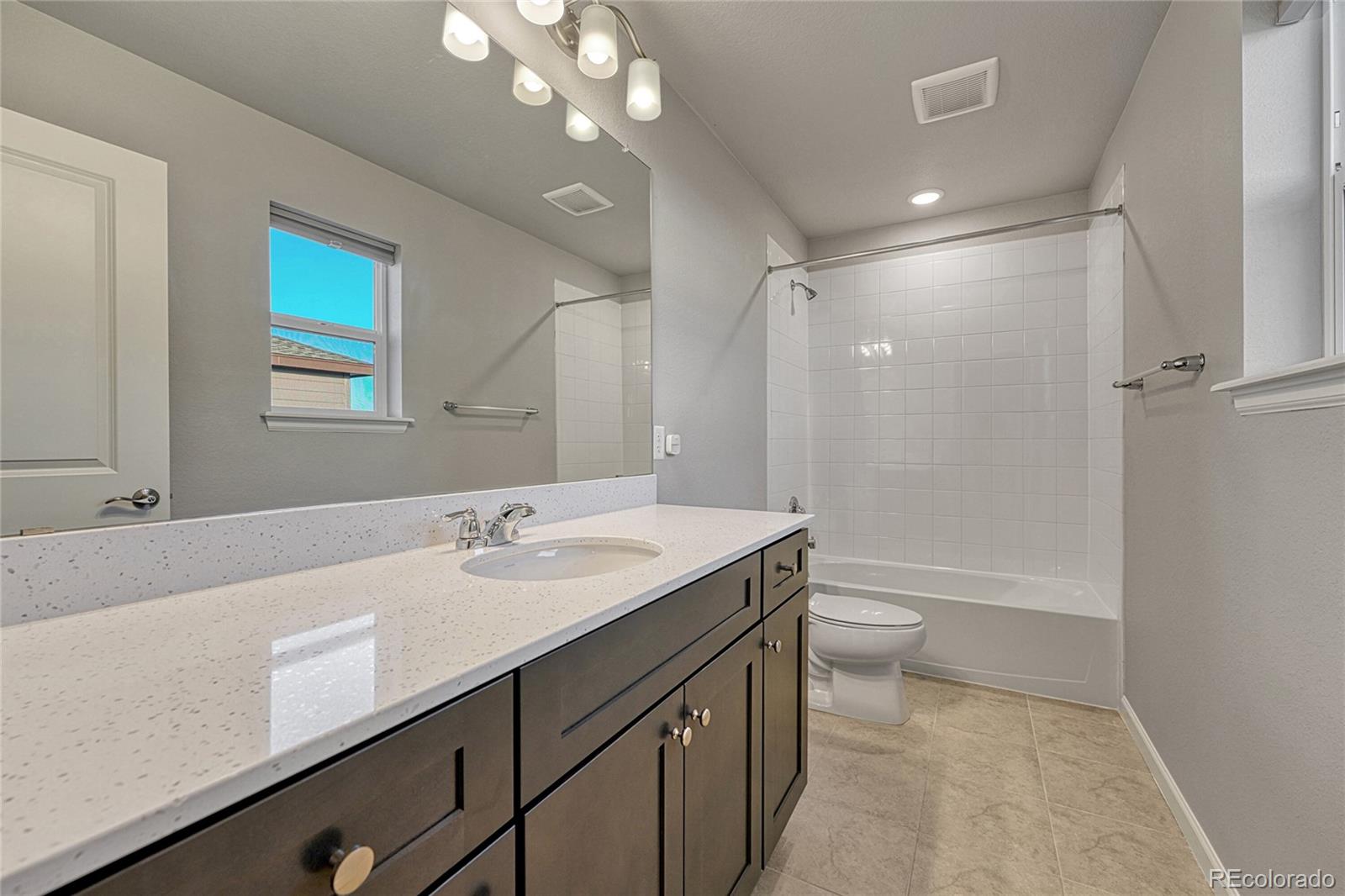 15902 Stringhalt Way Parker, CO 80134 - Photo 39 of 48 a bathroom with a sink a toilet a mirror and shower