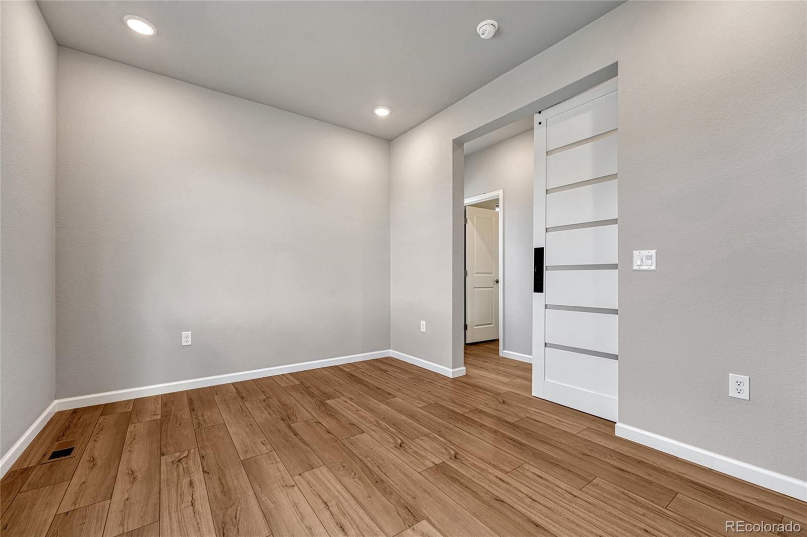 15902 Stringhalt Way Parker, CO 80134 - Photo 8 of 48 a view of empty room with wooden floor