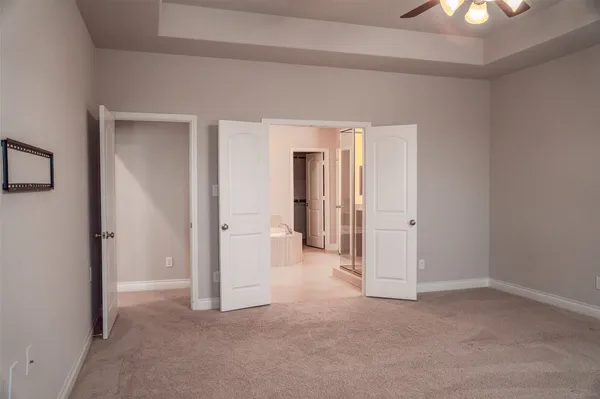 a view of a room with a hallway and a chandelier