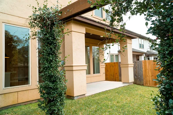 a view of backyard with tub and wooden fence