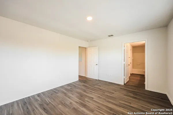 a view of an empty room and wooden floor