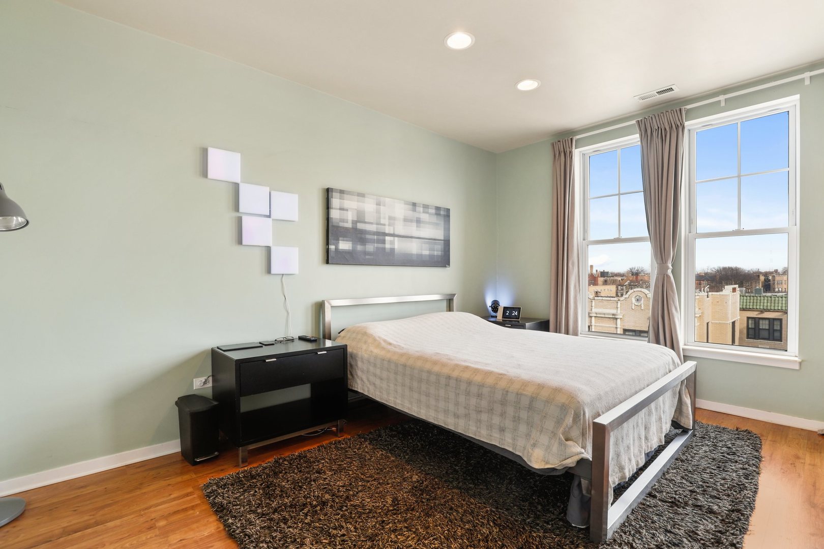 7243 Madison Street, Unit 421 Forest Park, IL 60130 - Photo 11 of 21 a bedroom with a bed lamp and a window