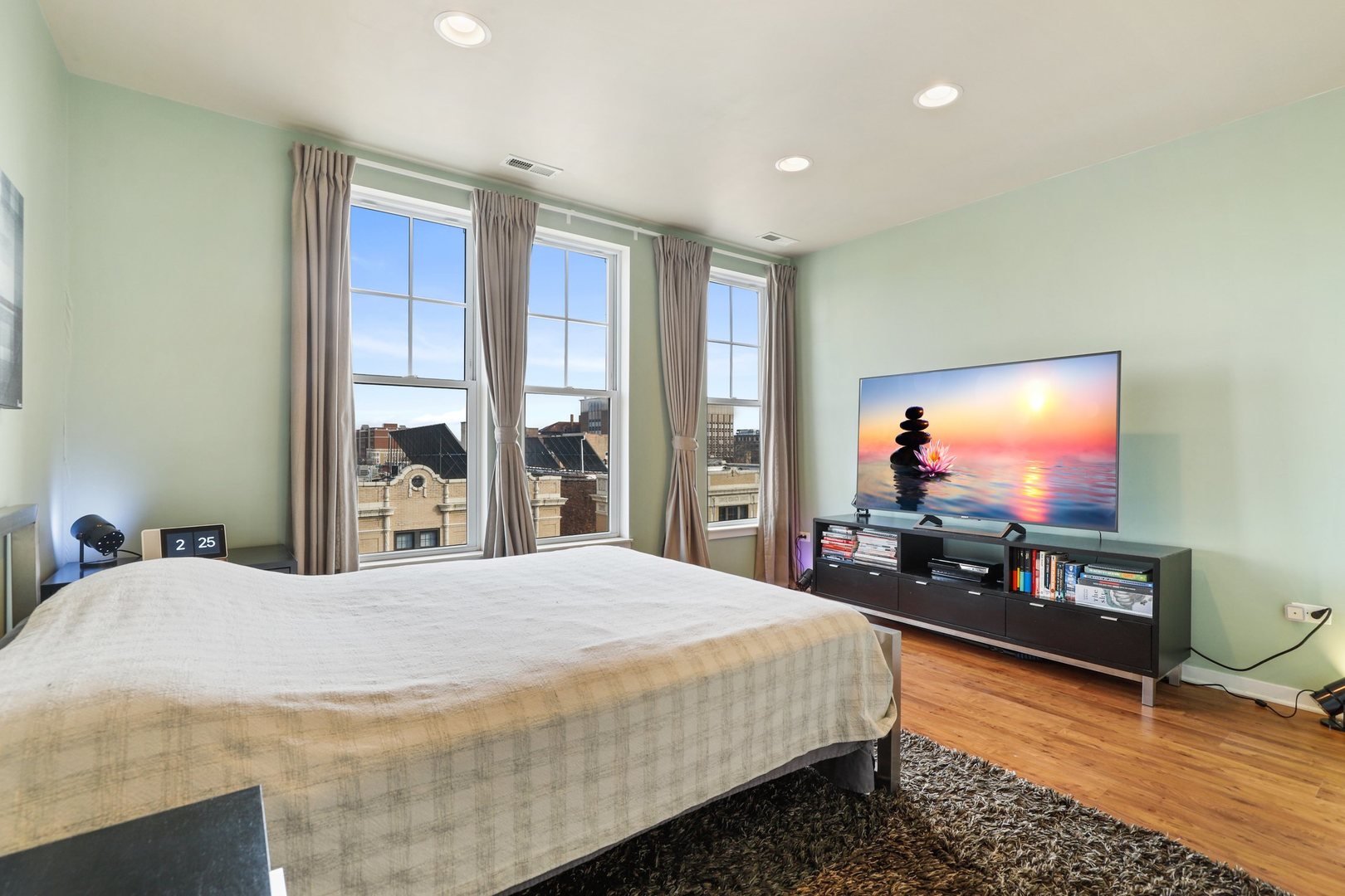 7243 Madison Street, Unit 421 Forest Park, IL 60130 - Photo 12 of 21 a bedroom with a bed and a flat screen tv