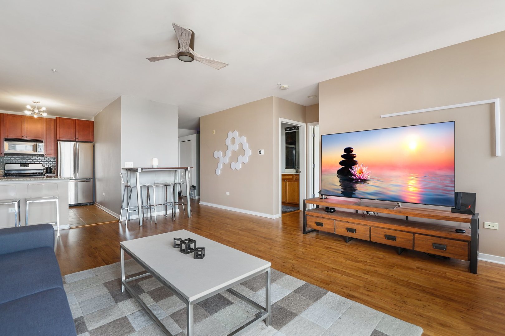 7243 Madison Street, Unit 421 Forest Park, IL 60130 - Photo 6 of 21 a living room with furniture a rug and a flat screen tv
