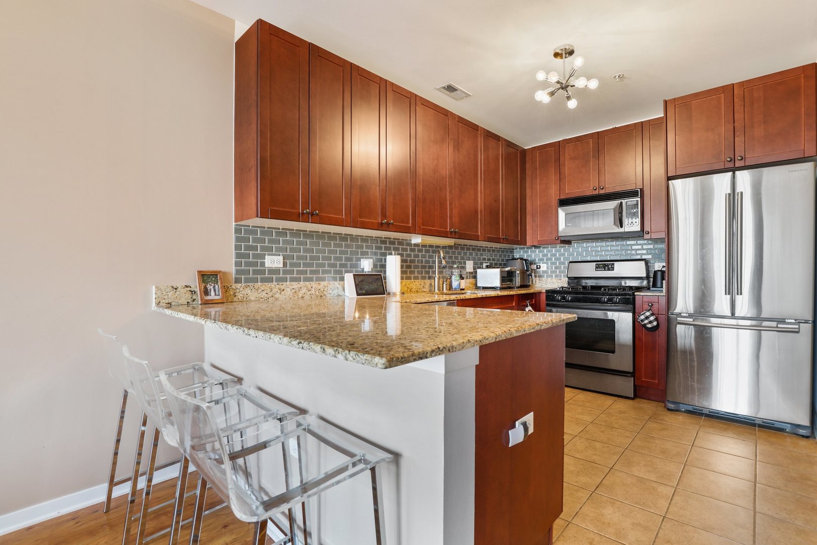 7243 Madison Street, Unit 421 Forest Park, IL 60130 - Photo 8 of 21 a kitchen with granite countertop stainless steel appliances and wooden cabinets
