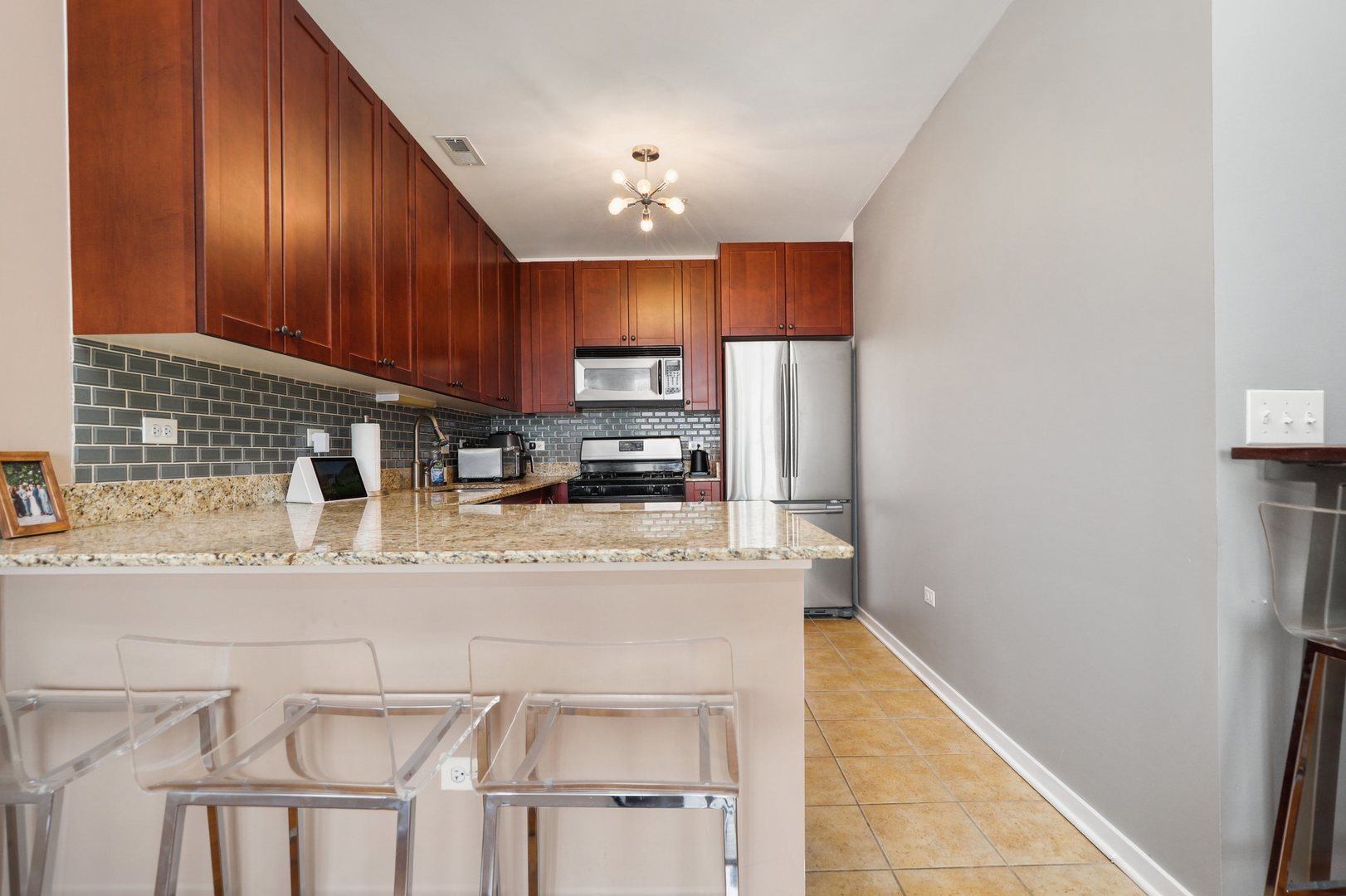 7243 Madison Street, Unit 421 Forest Park, IL 60130 - Photo 9 of 21 a kitchen with stainless steel appliances granite countertop a refrigerator a stove top oven a sink and dishwasher