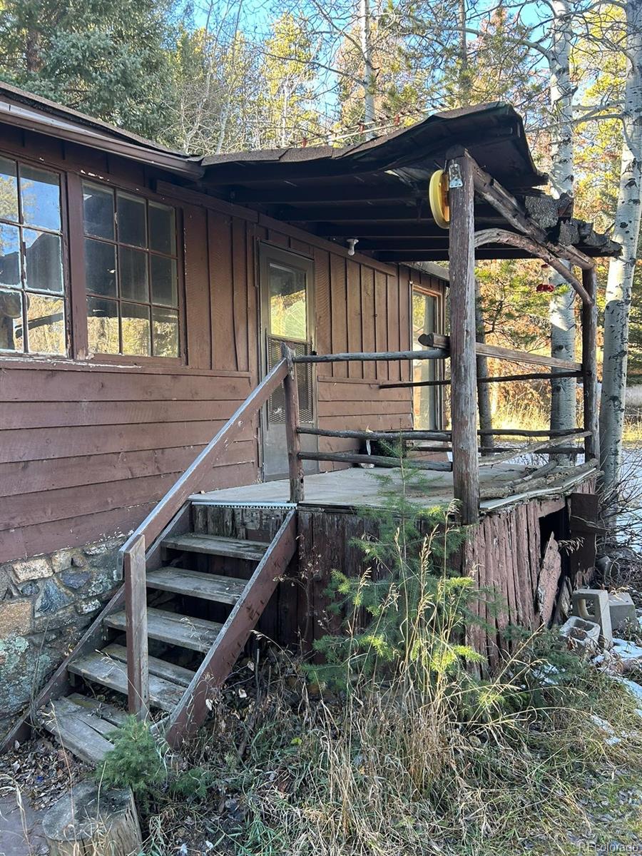 10881 Kitty Drive Conifer, CO 80433 - Photo 3 of 29 a view of a house with backyard and deck
