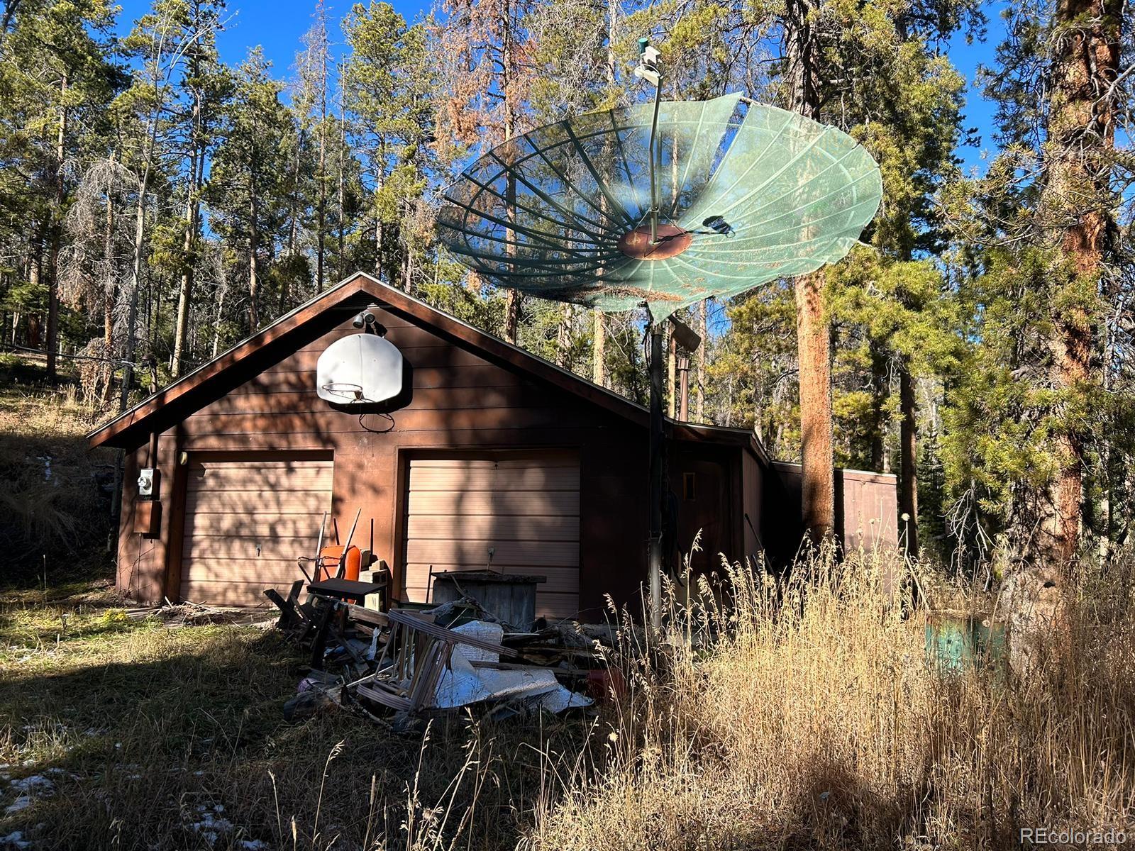 10881 Kitty Drive Conifer, CO 80433 - Photo 5 of 29 a view of a house with a tree in a yard