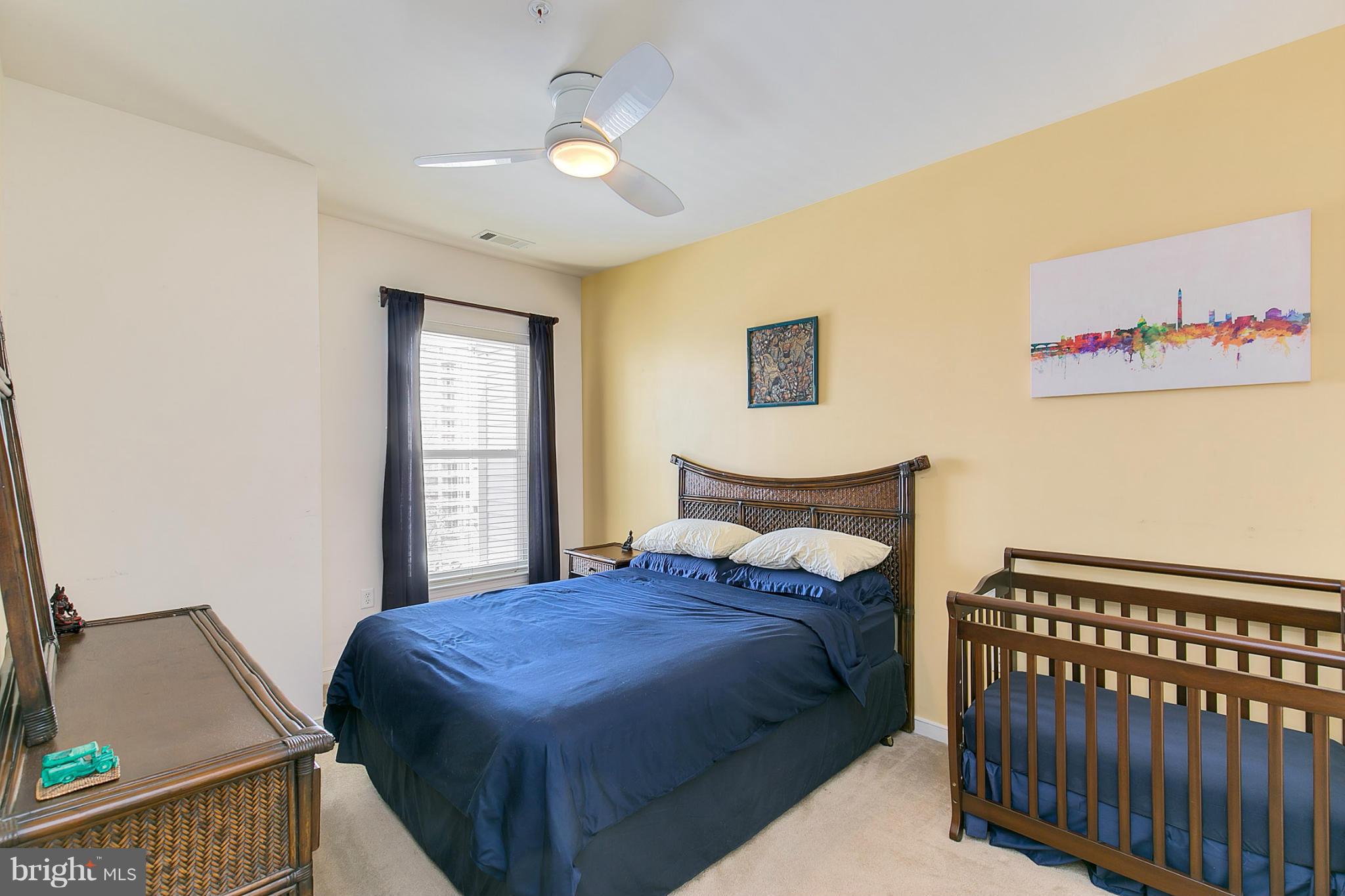 8045 Newell Street, Unit 513 Silver Spring, MD 20910 - Photo 14 of 21 a bedroom with a bed and a window
