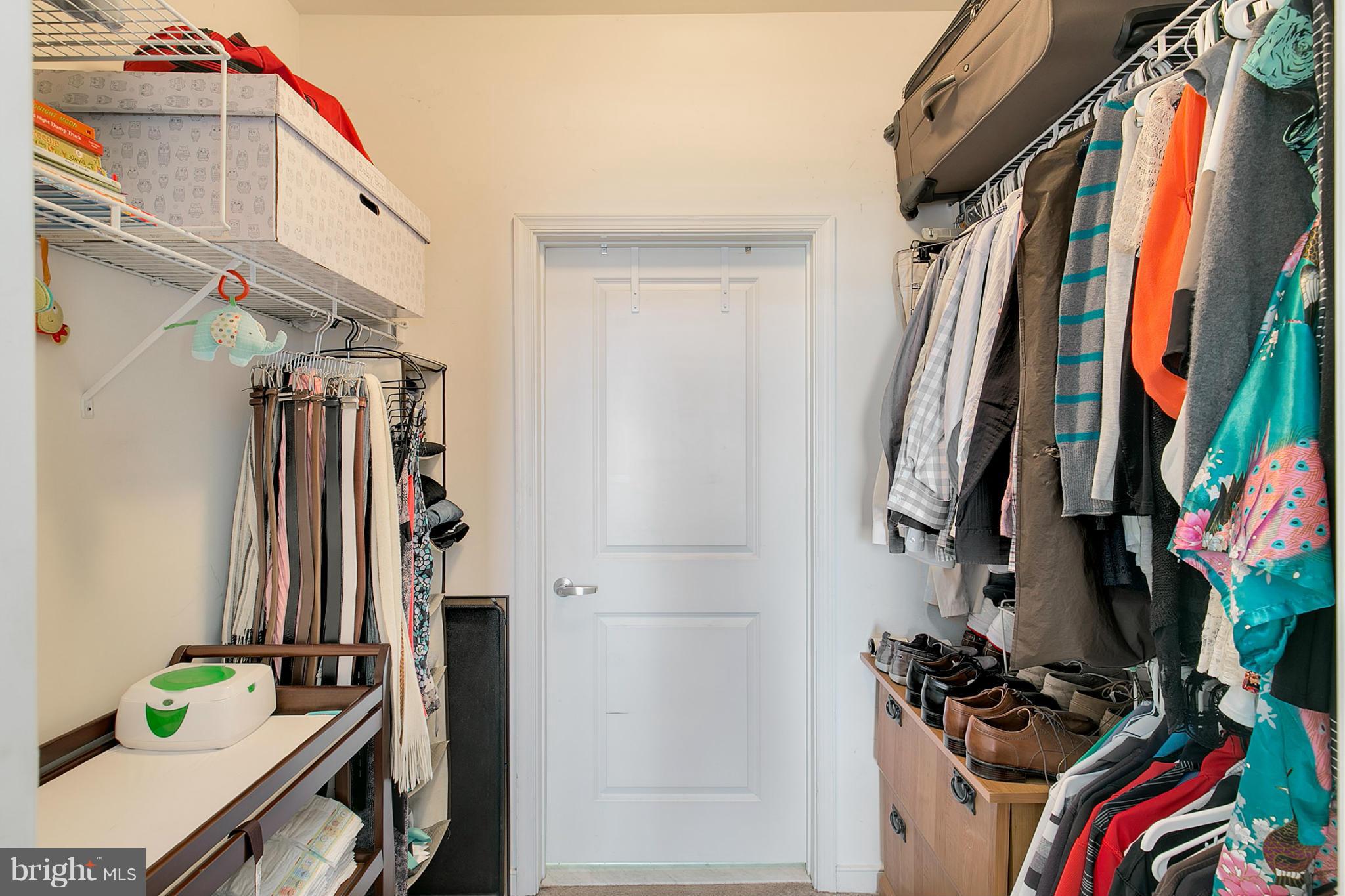 8045 Newell Street, Unit 513 Silver Spring, MD 20910 - Photo 16 of 21 a view of walk in closet with clothes and shoes