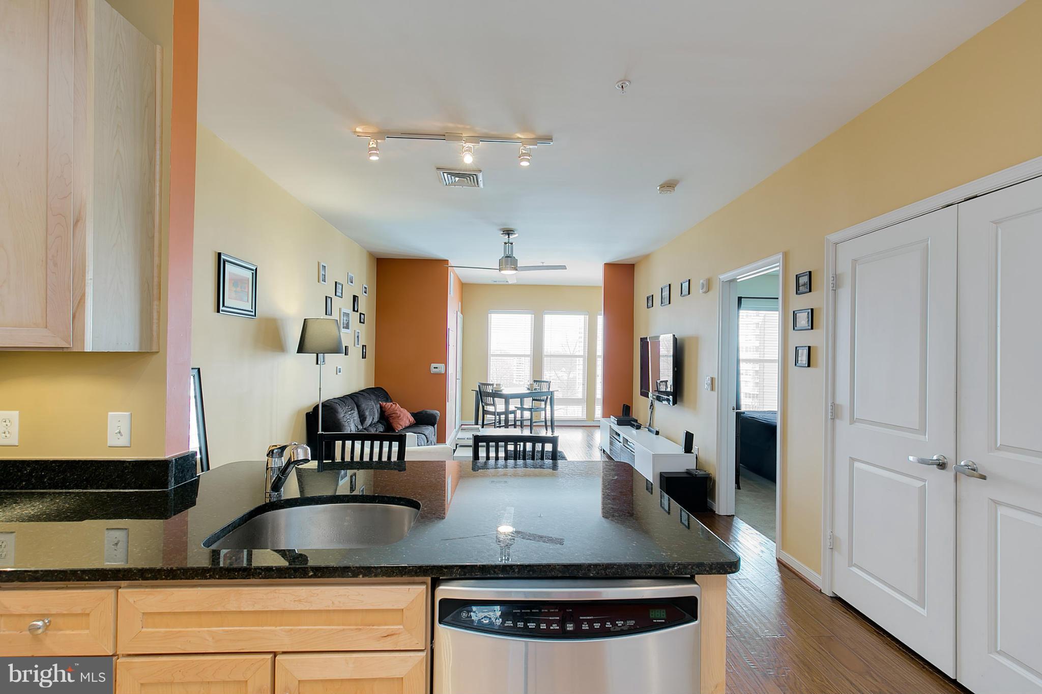 8045 Newell Street, Unit 513 Silver Spring, MD 20910 - Photo 7 of 21 a kitchen with stainless steel appliances granite countertop a sink a stove and white cabinets