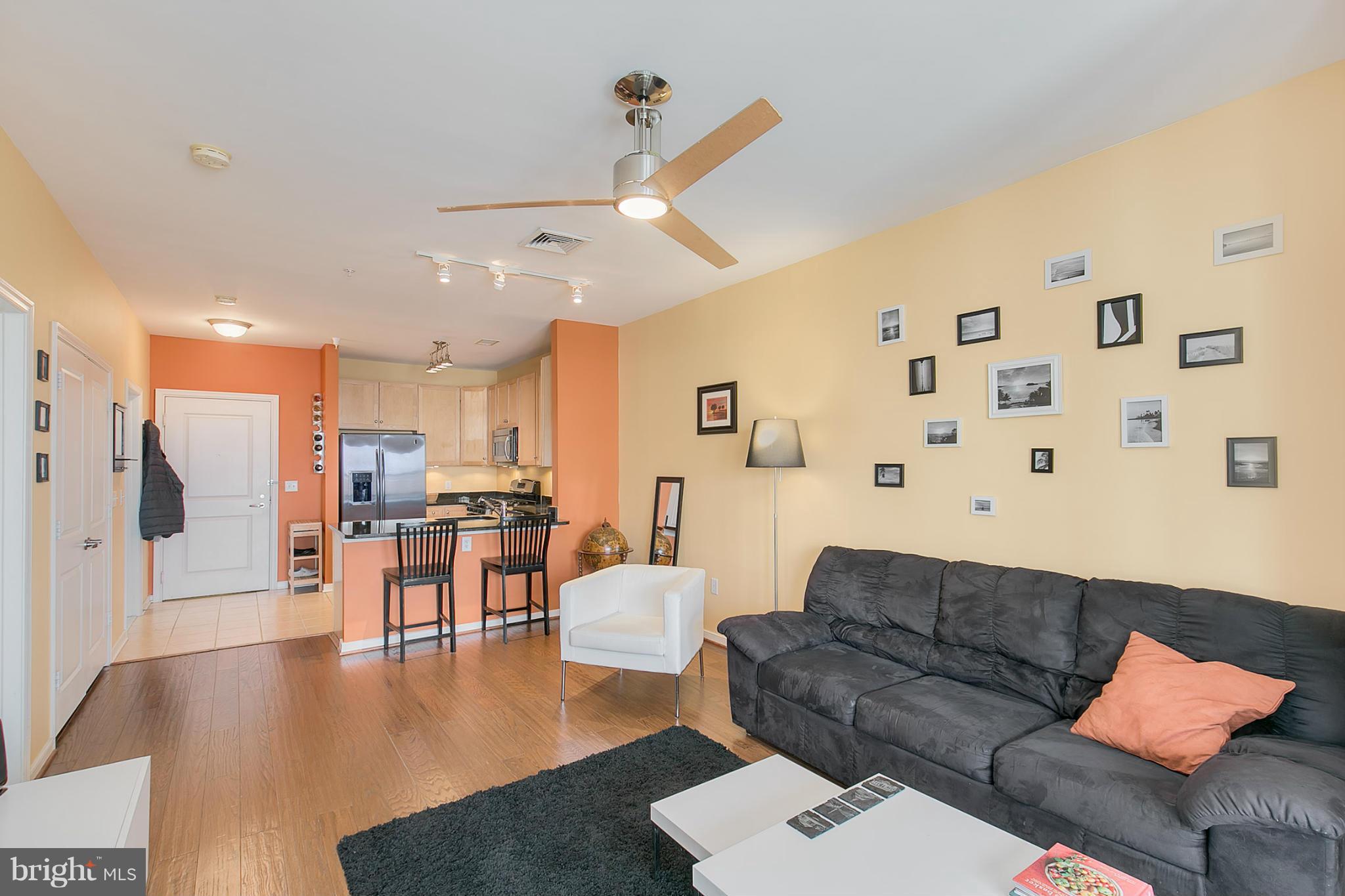 8045 Newell Street, Unit 513 Silver Spring, MD 20910 - Photo 9 of 21 a living room with furniture and wooden floor