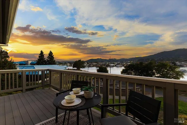 a view of a balcony with wooden floor and city view