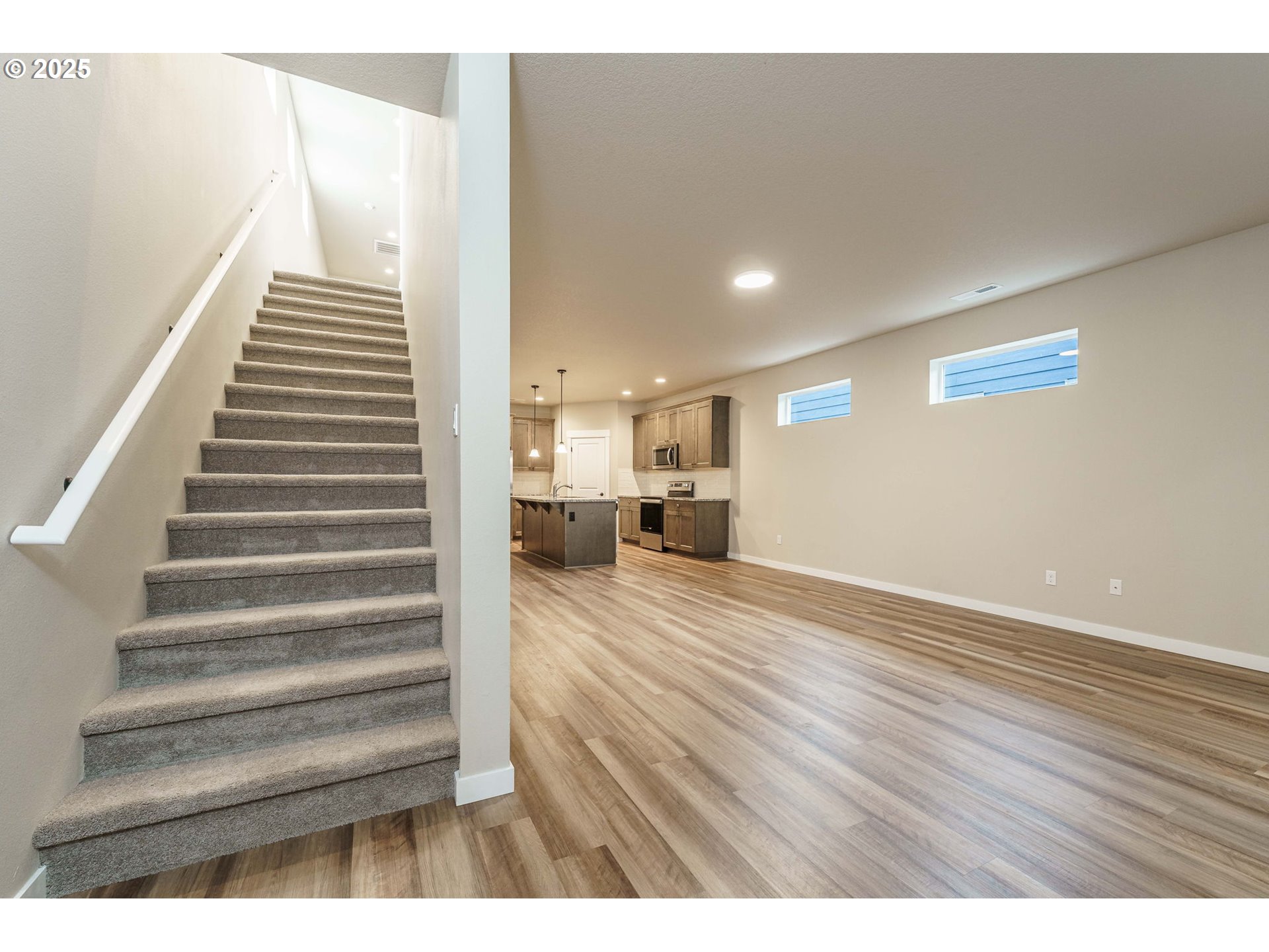 7135 South 13th Street Ridgefield, WA 98642 - Photo 17 of 40 a view of a room with wooden floor and staircase