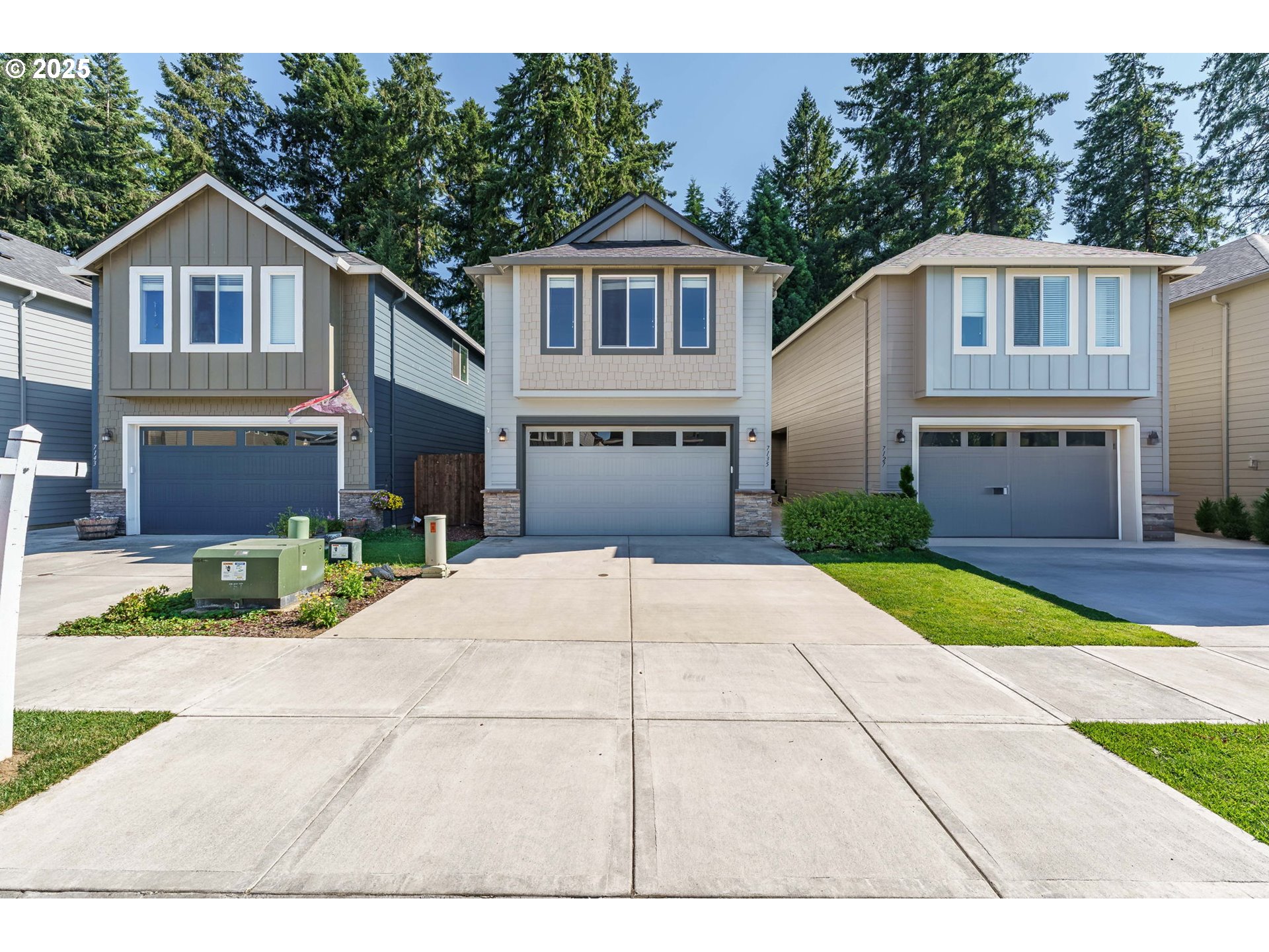 7135 South 13th Street Ridgefield, WA 98642 - Photo 2 of 40 a front view of a house with a yard and garage
