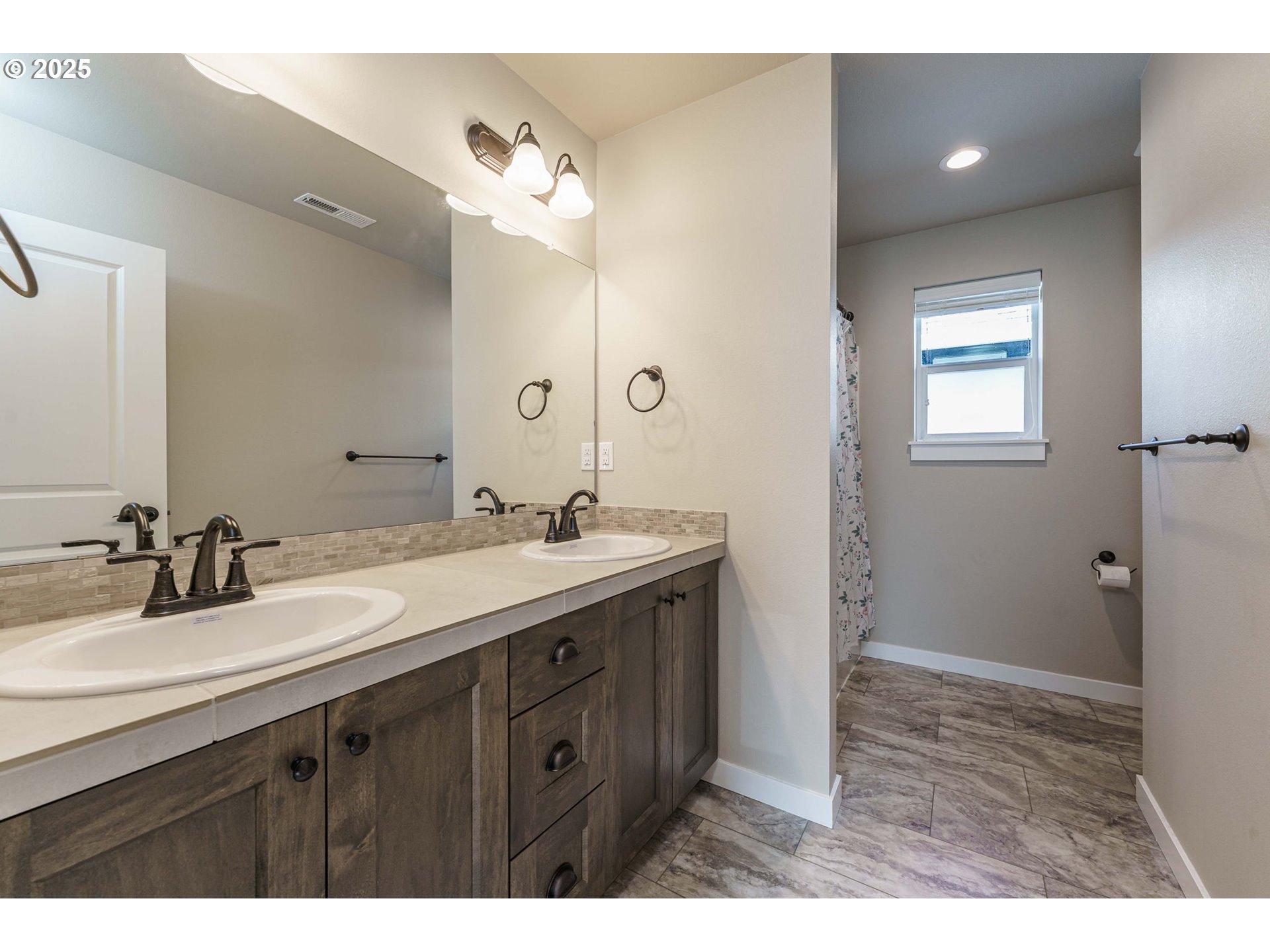 7135 South 13th Street Ridgefield, WA 98642 - Photo 30 of 40 a bathroom with a double vanity sink and mirror