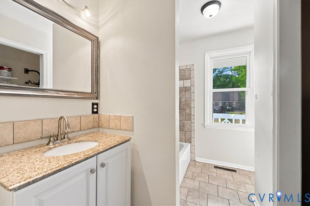21103 Rabbit Run Petersburg, VA 23803 - Photo 17 of 27 Bright bathroom featuring a granite-topped vanity