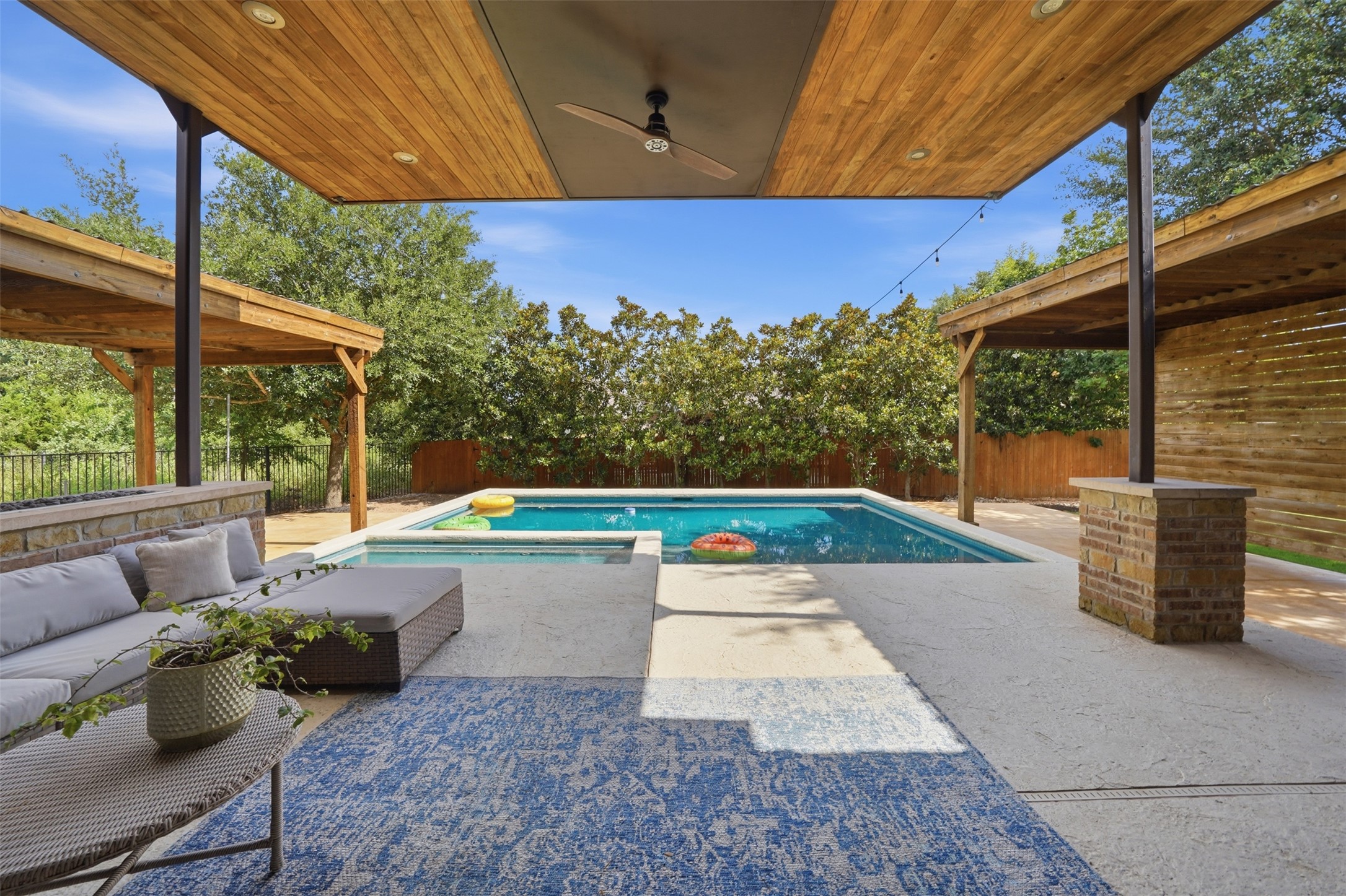 8729 Vantage Point Drive Austin, TX 78737 - Photo 21 of 33 An inviting backyard oasis offers a sparkling pool and shaded patio for ultimate relaxation.