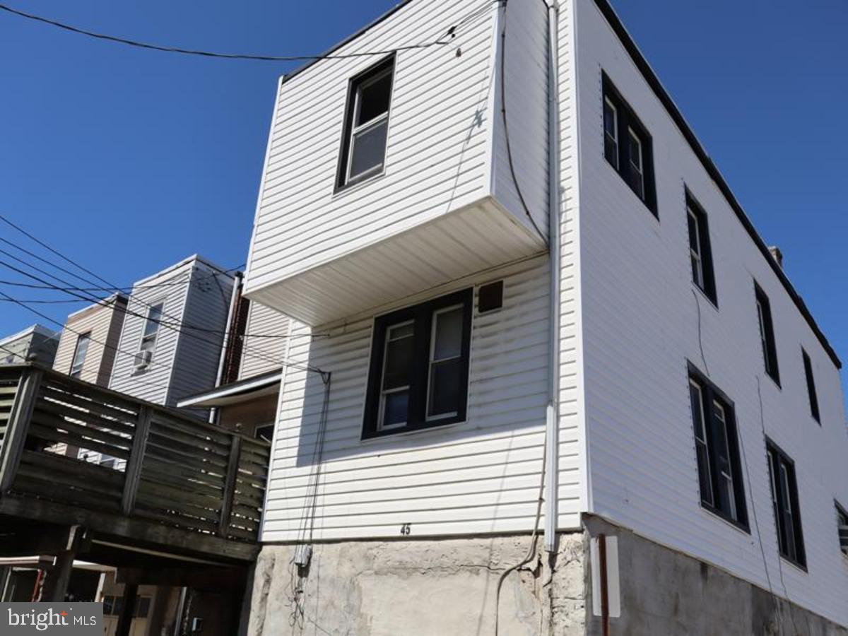 45 Golf Road Upper Darby, PA 19082 - Photo 4 of 13 a view of a house with more windows and wooden stairs
