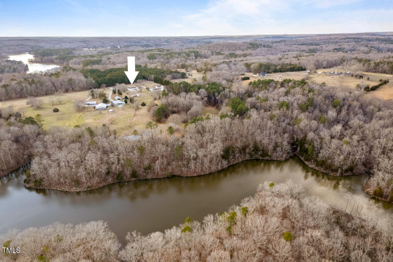 7409 Blalock Road Bahama, NC 27503 - Photo 40 of 43 an aerial view of residential houses with outdoor space and lake view