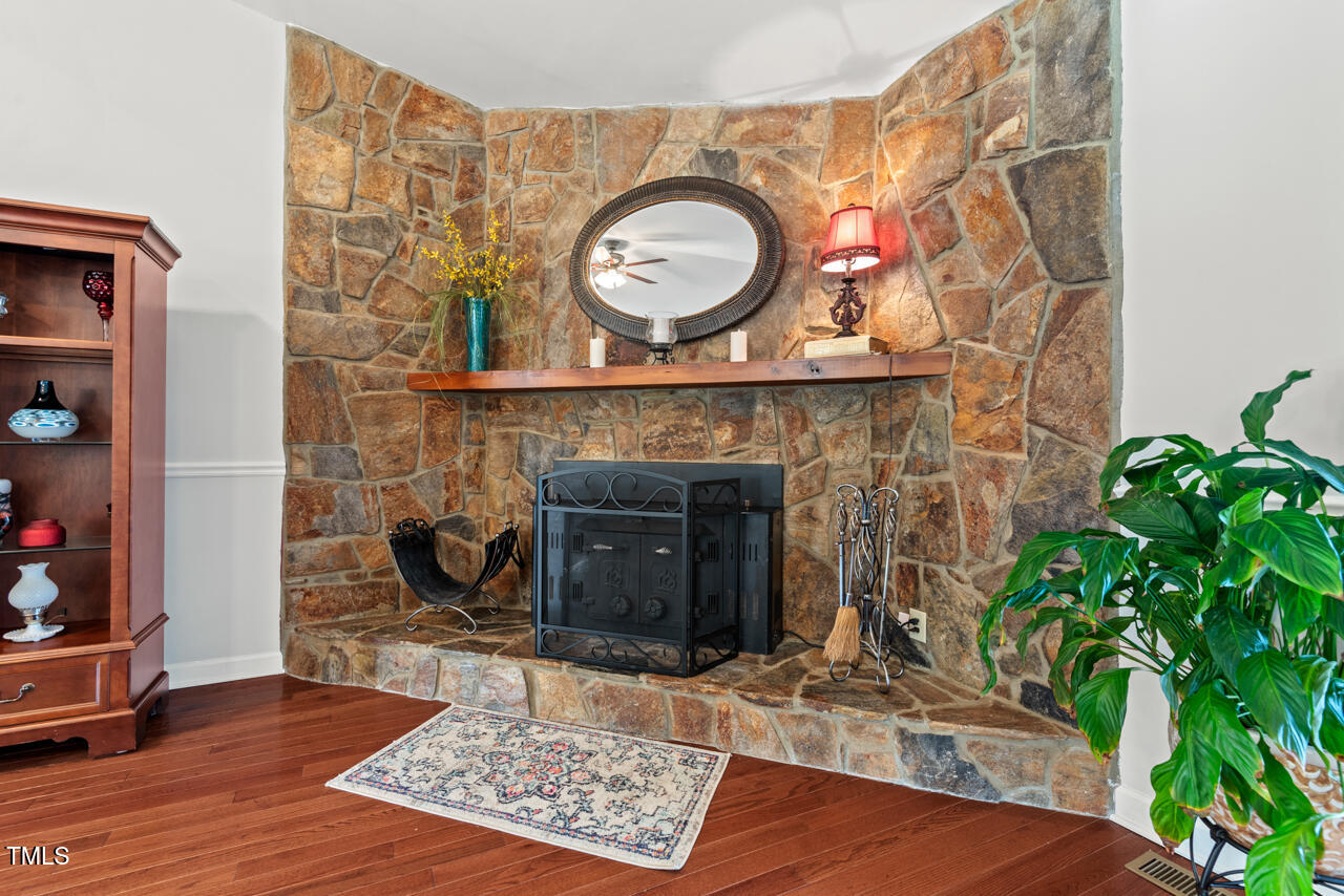 7409 Blalock Road Bahama, NC 27503 - Photo 8 of 43 a living room with a fireplace and a potted plant