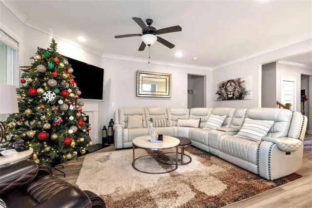 a living room with furniture and a flat screen tv