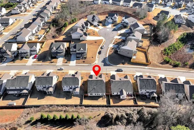 an aerial view of a house with a yard and a outdoor view