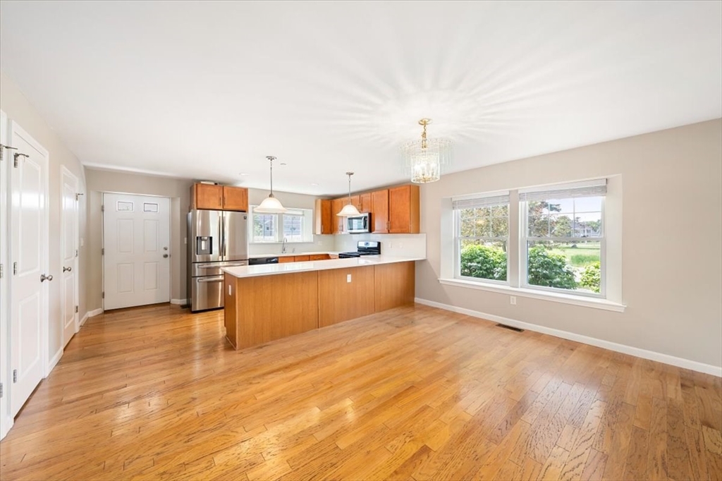 6 Bates Street, Unit A Devens, MA 01434 - Photo 9 of 41 a large kitchen with kitchen island a sink stainless steel appliances and cabinets