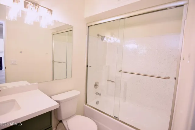 a bathroom with a shower a toilet and a sink