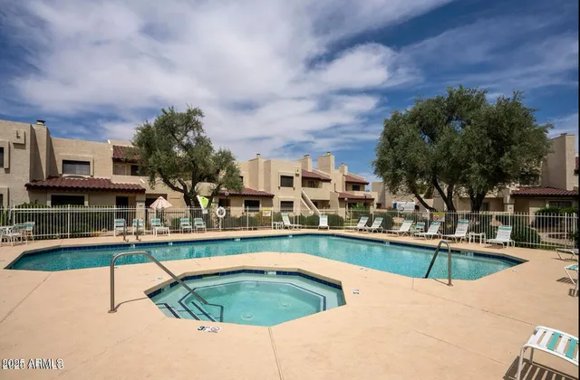 a view of a swimming pool with outdoor seating