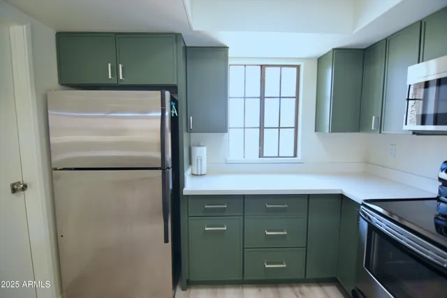 a kitchen with a refrigerator and a sink