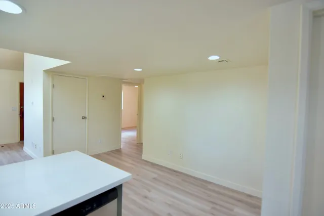 a view of hallway with wooden floor