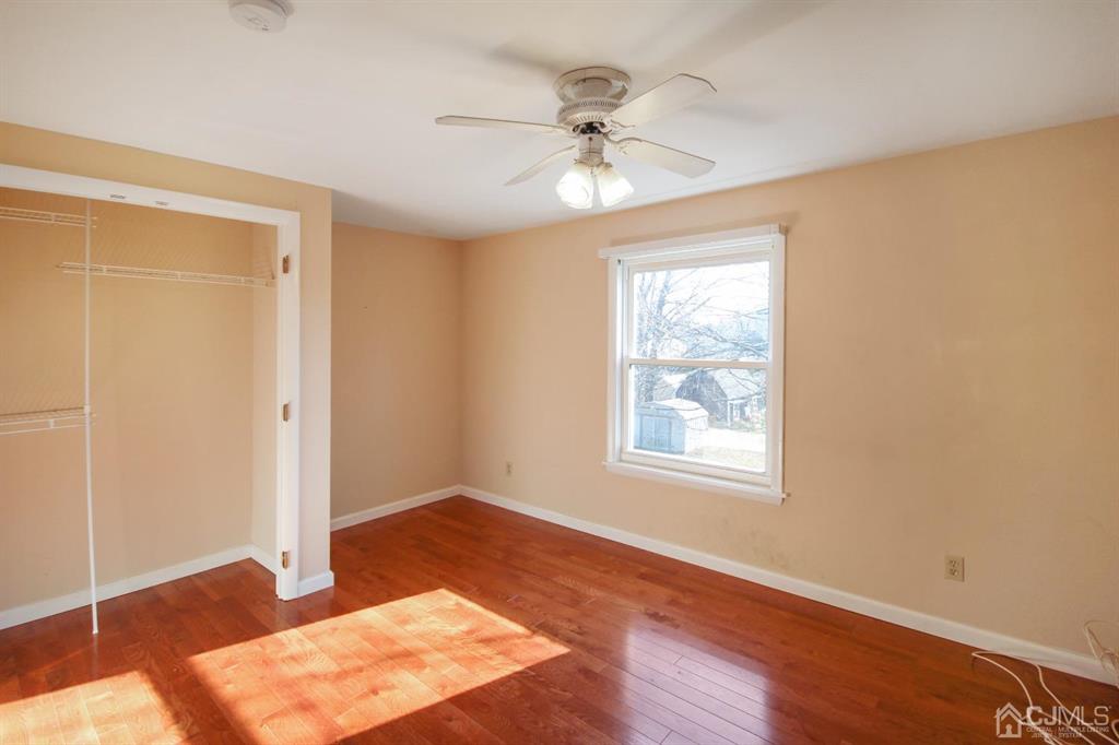 49 Racetrack Road East Brunswick, NJ 08816 - Photo 11 of 20 a view of an empty room with wooden floor and a window