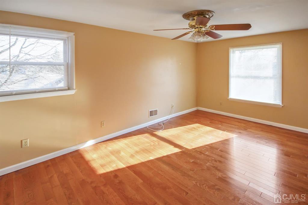 49 Racetrack Road East Brunswick, NJ 08816 - Photo 13 of 20 wooden floor in an empty room with a window