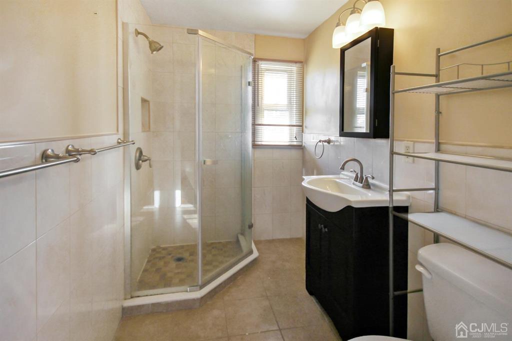 49 Racetrack Road East Brunswick, NJ 08816 - Photo 15 of 20 a bathroom with a sink and a mirror