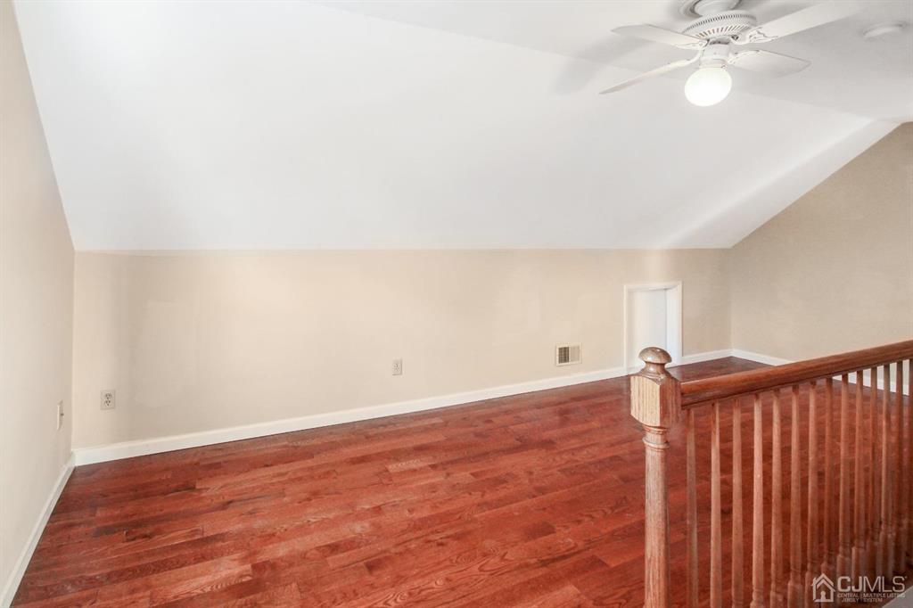 49 Racetrack Road East Brunswick, NJ 08816 - Photo 17 of 20 an empty room with wooden floor fan and windows