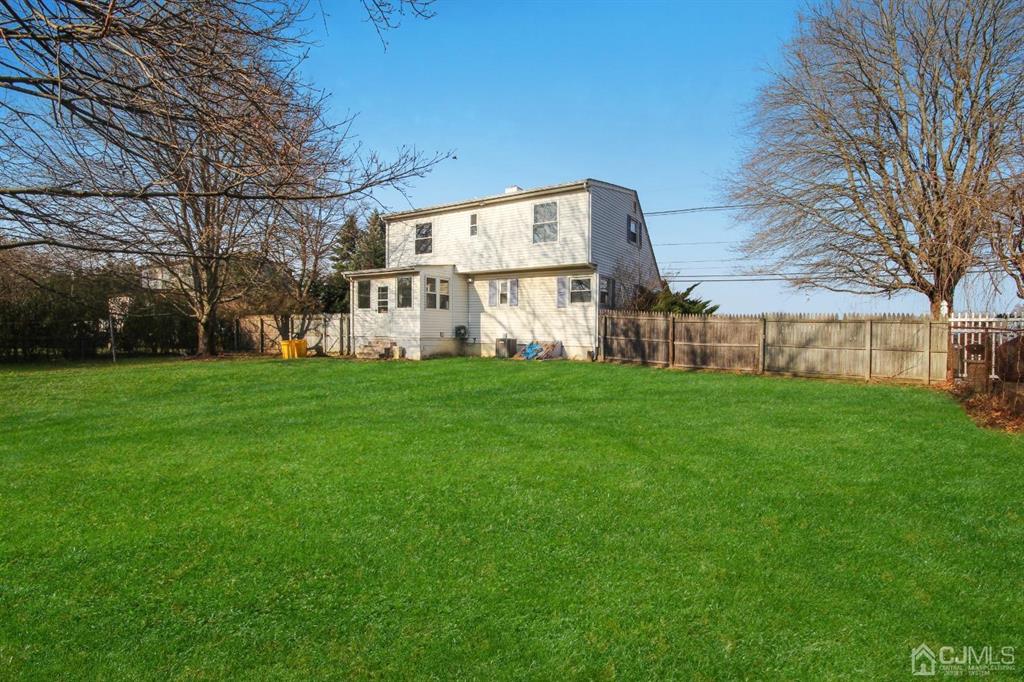 49 Racetrack Road East Brunswick, NJ 08816 - Photo 19 of 20 a view of a house with a big yard and large trees