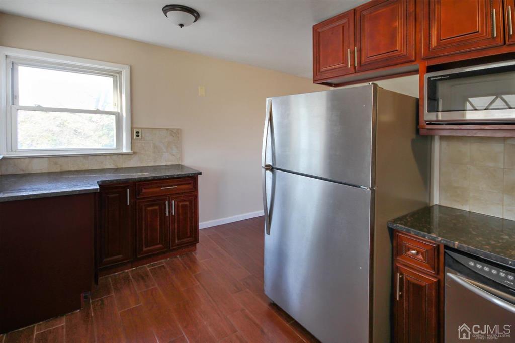 49 Racetrack Road East Brunswick, NJ 08816 - Photo 6 of 20 a kitchen with stainless steel appliances granite countertop a refrigerator a sink and dishwasher