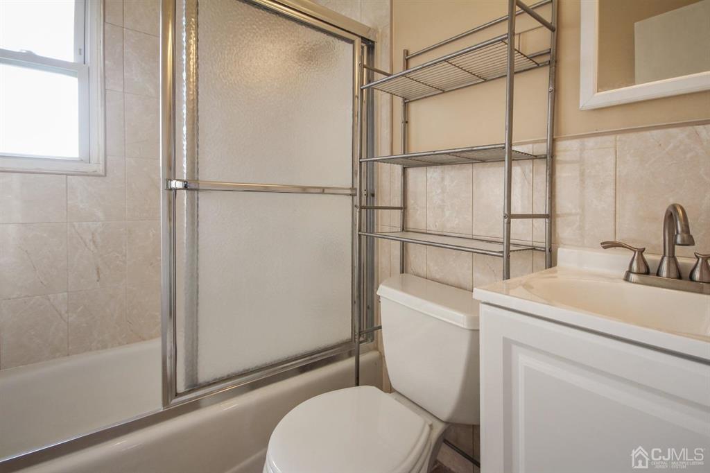 49 Racetrack Road East Brunswick, NJ 08816 - Photo 10 of 20 a bathroom with a sink toilet and shower
