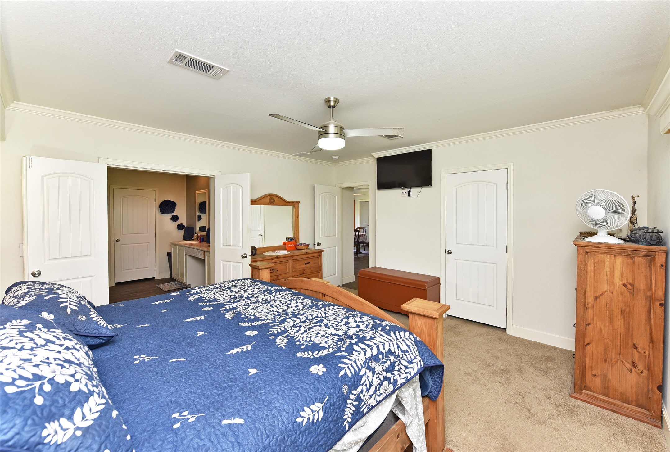 3221 Pecha Lane Rosenberg, TX 77471 - Photo 14 of 46 a bedroom with a large bed and a chandelier
