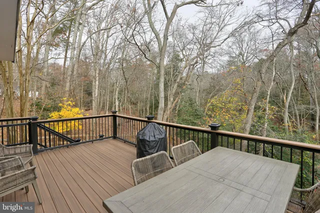 a view of balcony with wooden floor and fence