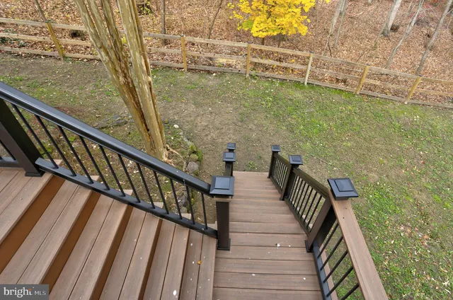 a view of a balcony with wooden floor and stairs