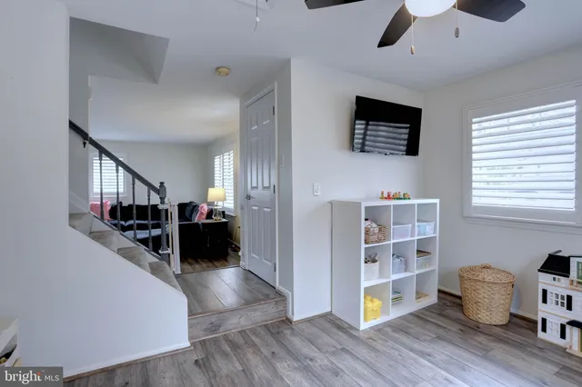 a living room with furniture and a book shelf