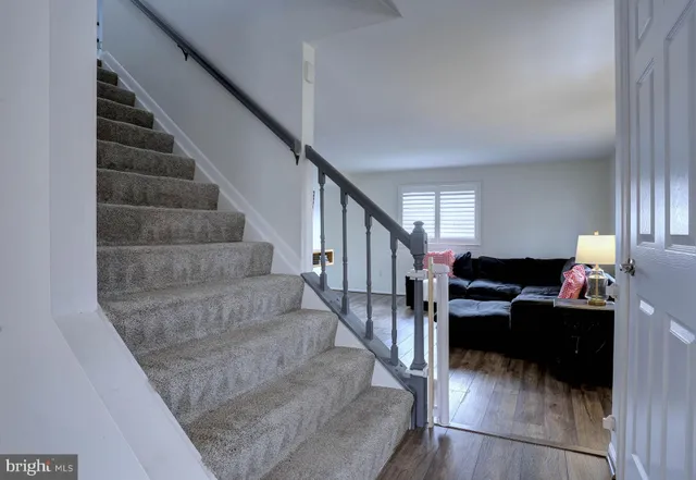 a view of living room with furniture and wooden floor