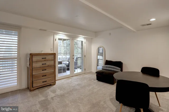 a living room with furniture and a floor to ceiling window