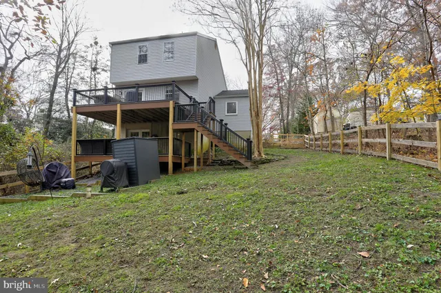 a view of a house with a yard and sitting area