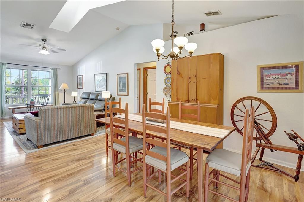 3520 2nd Avenue Northeast Naples, FL 34120 - Photo 17 of 39 a very nice looking dining room with furniture a chandelier and wooden floor